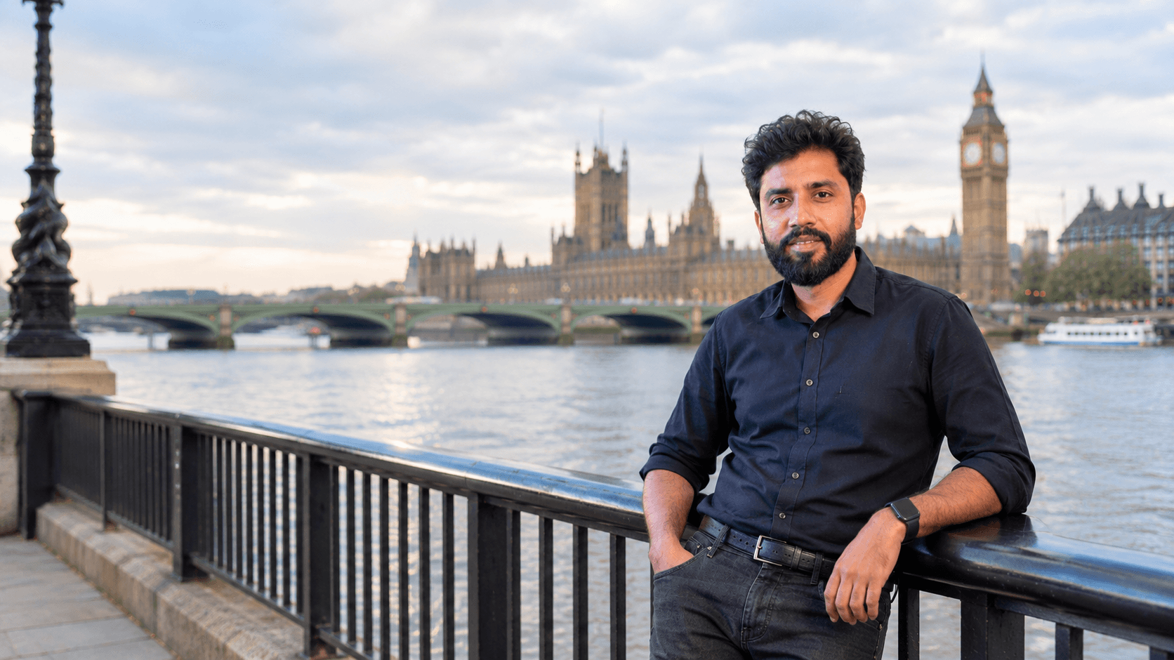 Mohd Ausaf in London, with the Houses of Parliament and the Thames behind him